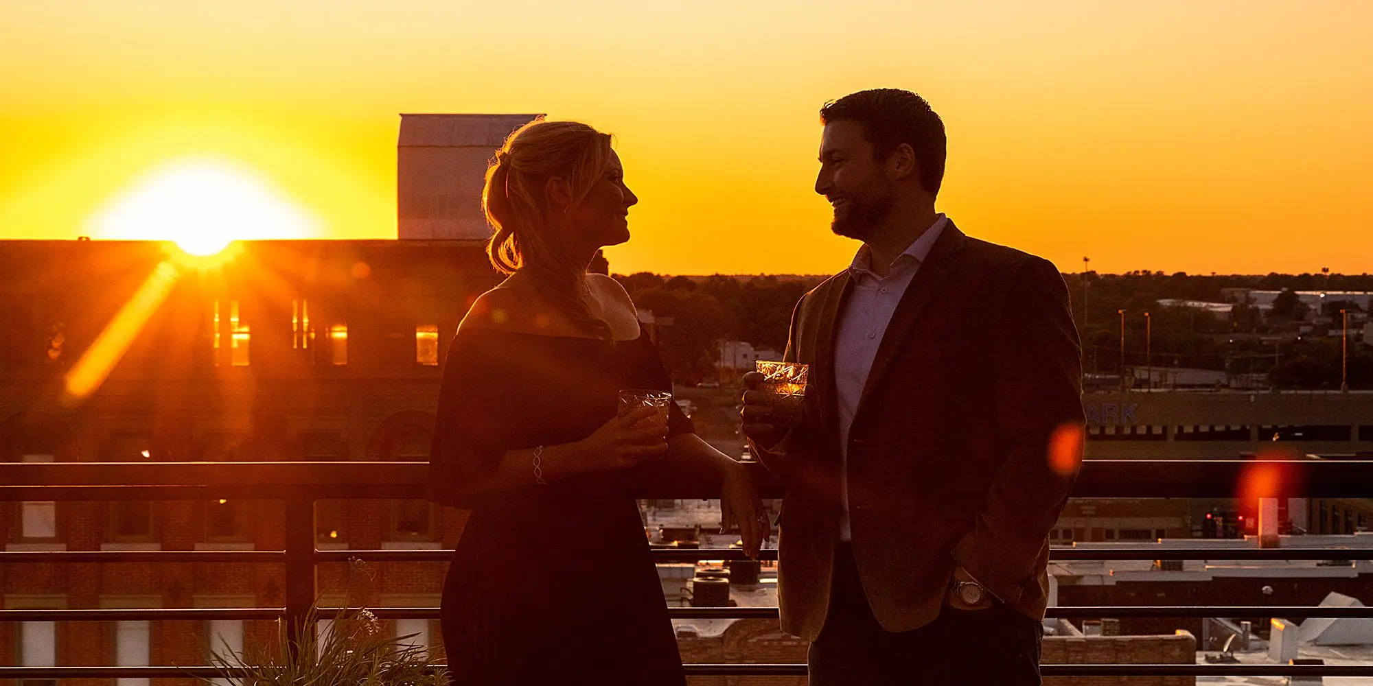 Couple enjoying a Springfield MO sunset from Vantage Rooftop Lounge