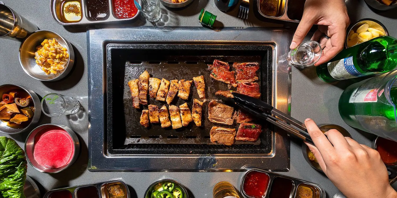Overhead shot of grill built into a table at Bawi Korean BBQ in Springfield MO