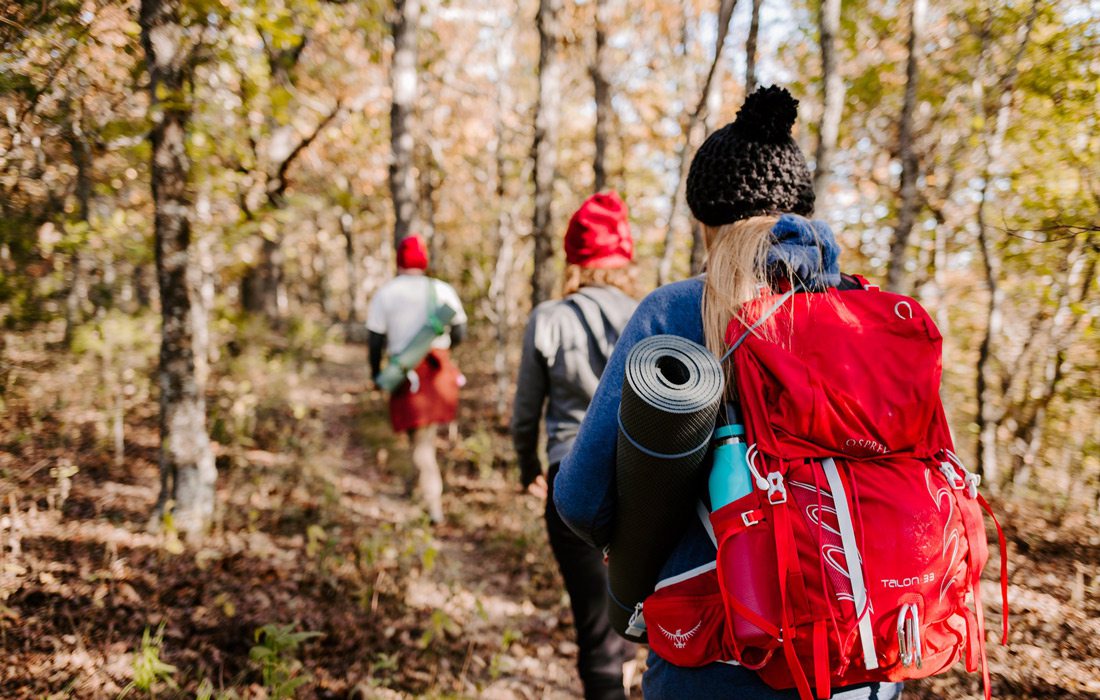 Photo of hikers in the woods on a winter hike.