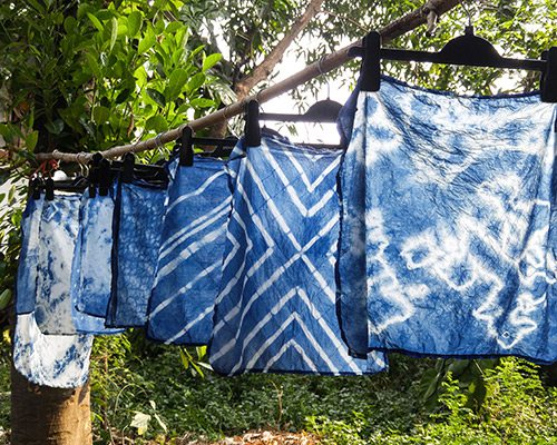 Blue shibori hangs to dry outdoors