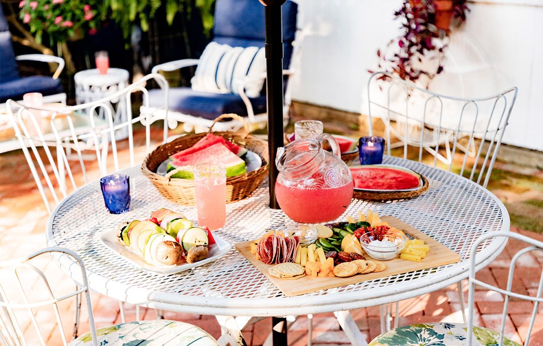 Drinks and snacks on table in back yard patio