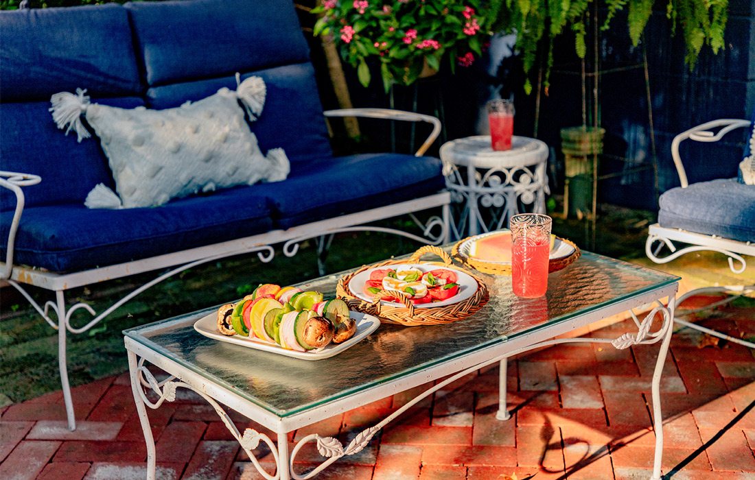 Seating and tables with food on back yard patio