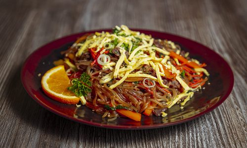 A plate of Koriya's japchae, a sweet-and-savory dish featuring noodles, beef bulgogi and vegetables