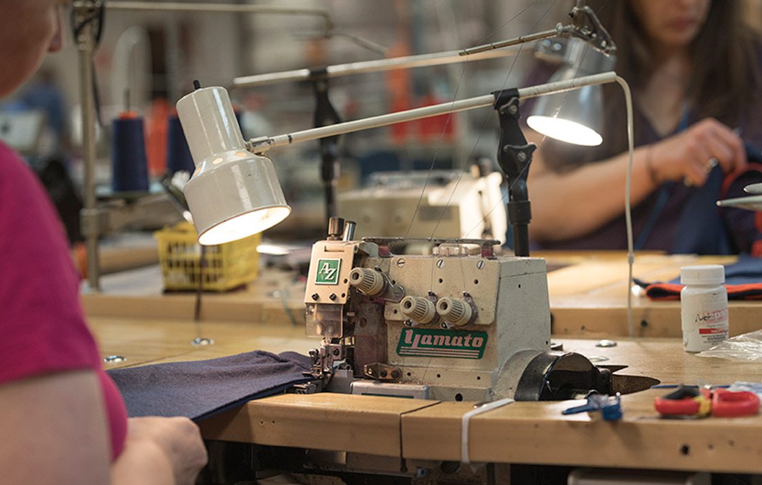 Women working at a sewing station.