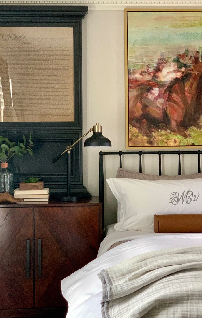 Bediset cabinet with black metal bedframe and black-and-gold bedside lamp.