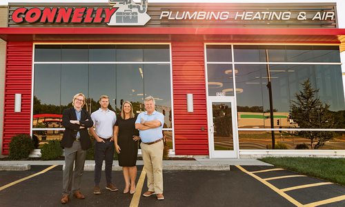 Connelly Plumbing's owners outside business.