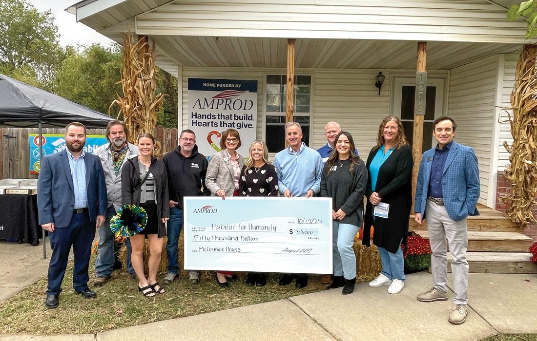 Amprod team with novelty-sized check.