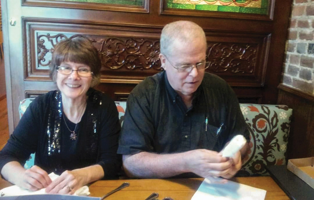 Claire and Mark Gidman, (right) roll silverware at Cafe Cusco in 2015.