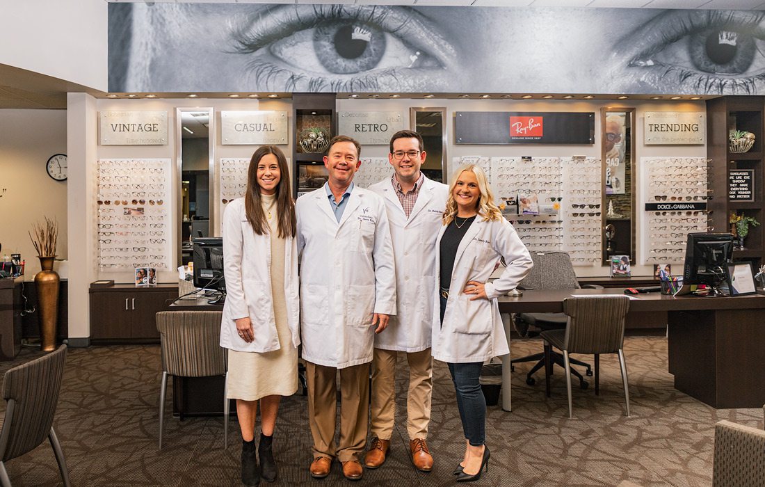 Four eye doctors stand together