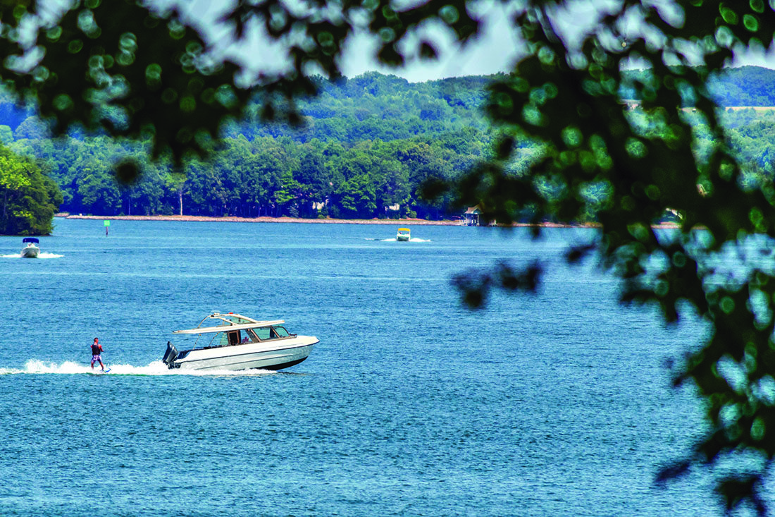 A boat zips across the surface of a lake.