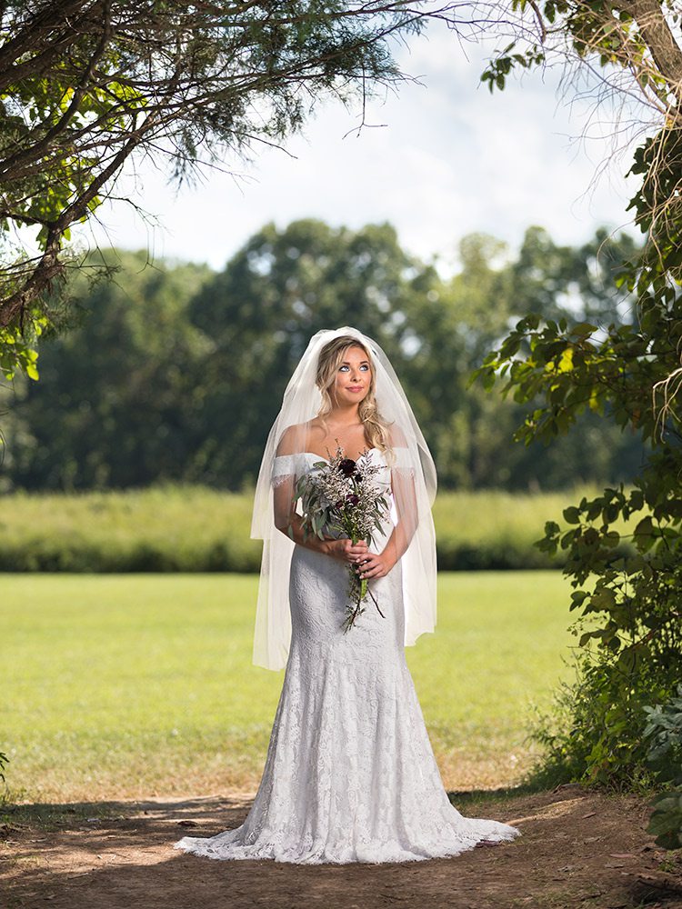 Off the shoulder white lace wedding gown at The Dress Springfield MO