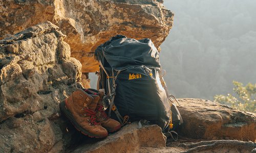 backpack and hiking boots out on a trail