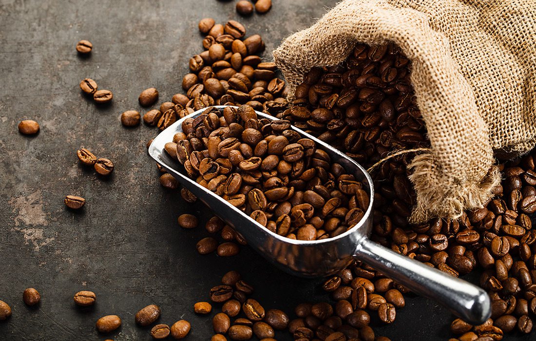 Coffee beans and a metal scoop