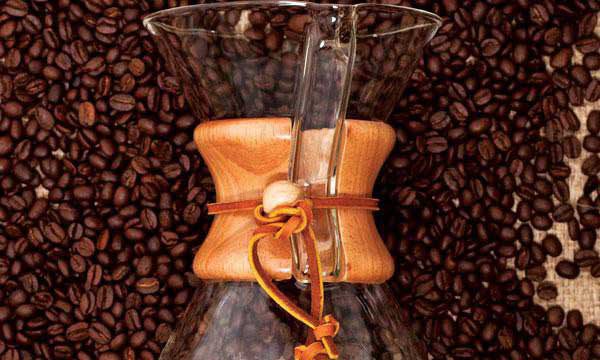 Coffee pitches sits on a layer of coffee beans