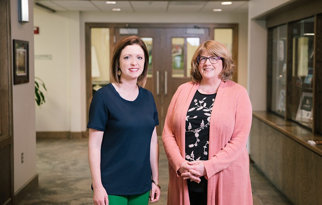 Winter Kinne and Louise Knauer in a hallway at CFO