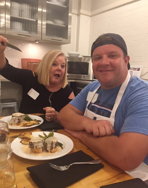 Joan and Dylan Whitaker sitting down to a meal they cooked in Greenwood, MS