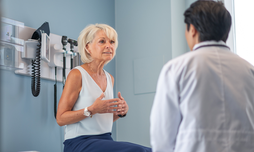 Women talks with her primary care doctor during a annual visit.