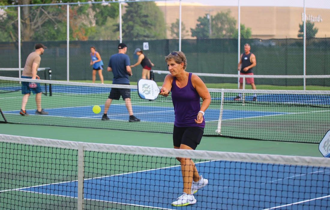 Woman playing pickleball on outdoor court in Springfield MO