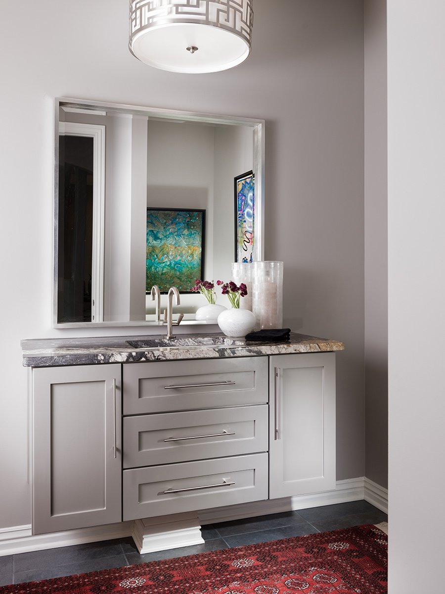 Modern powder bath with gray cabinets by Nathan Taylor.