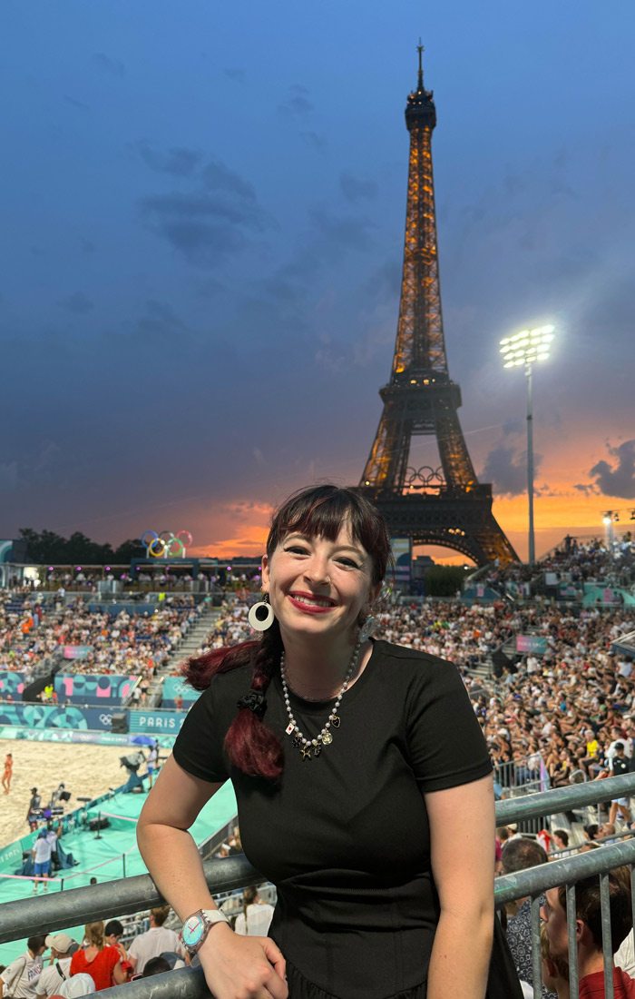 Elizabeth VanFosson in Paris with the Effiel Tower in the background