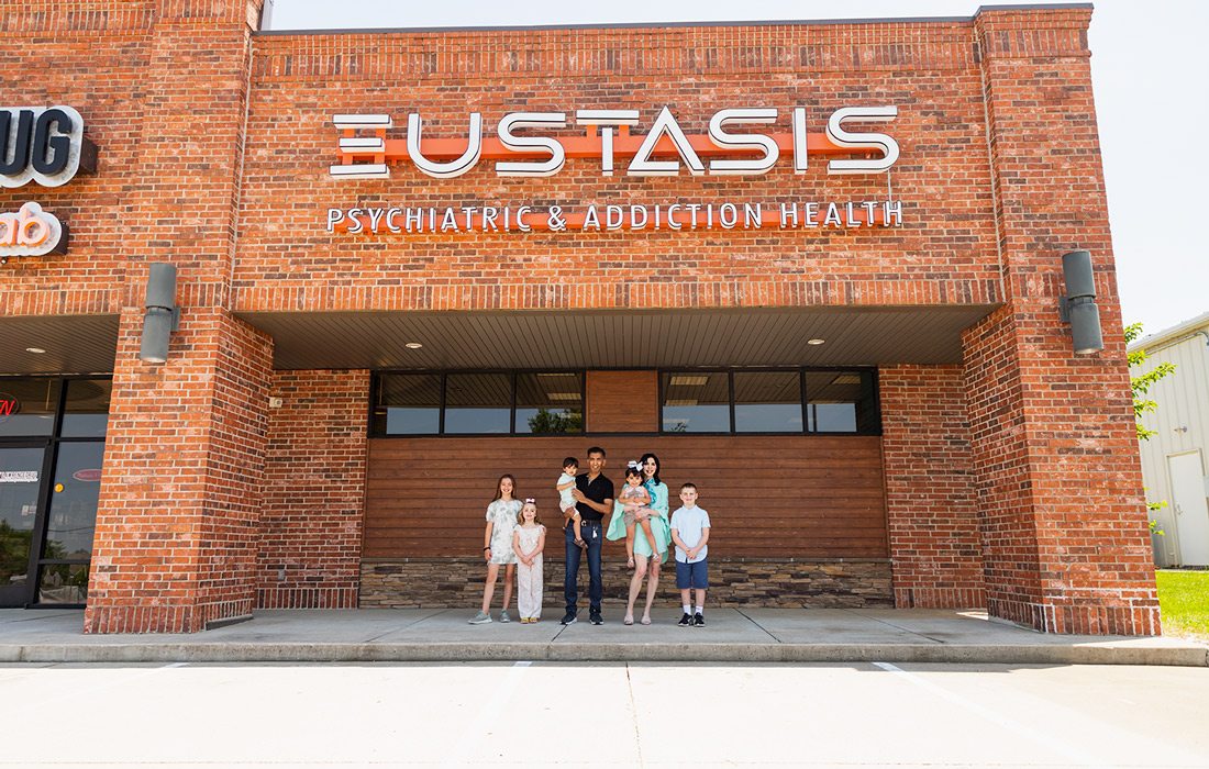 The Jains with their younger children in front of the new Ozark location.