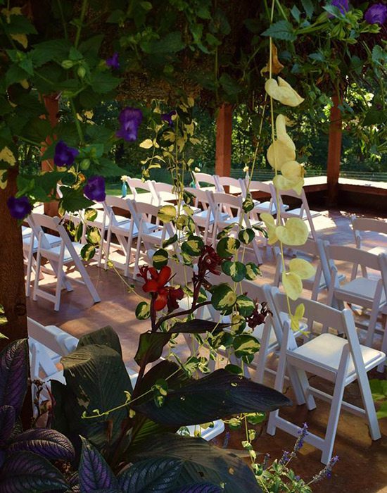 White chairs set for a wedding ceremony at Wheeler Gardens Venue at the Farm in Ozark MO