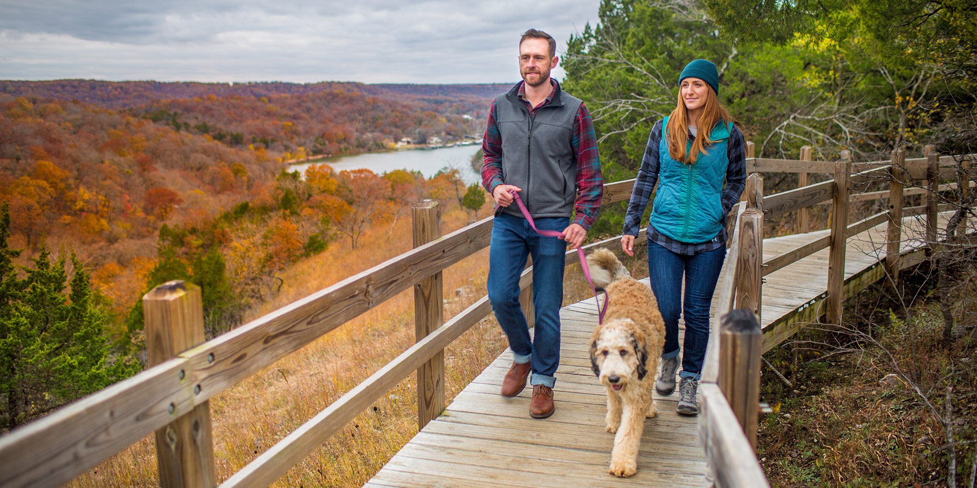 Young couple and their dog on a fall hike in Ha Ha Tonka in Camdenton, Missouri