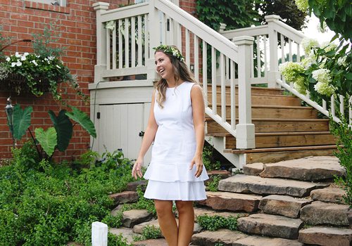 Katelyn Reynolds in white dress on steps