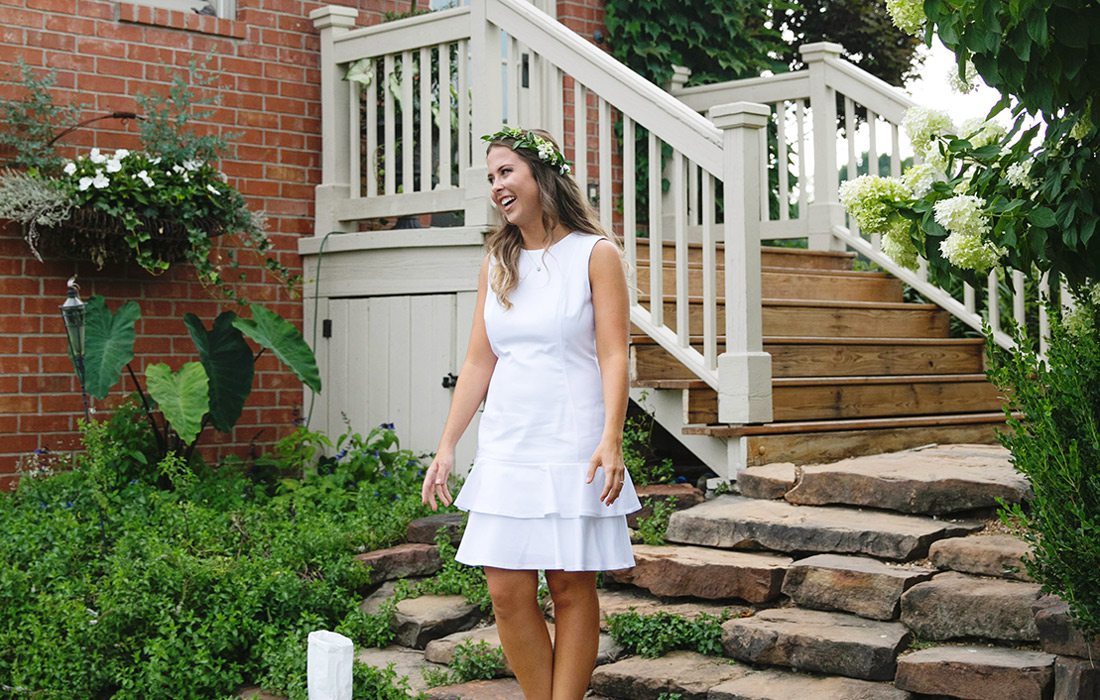 Katelyn Reynolds in white dress on steps