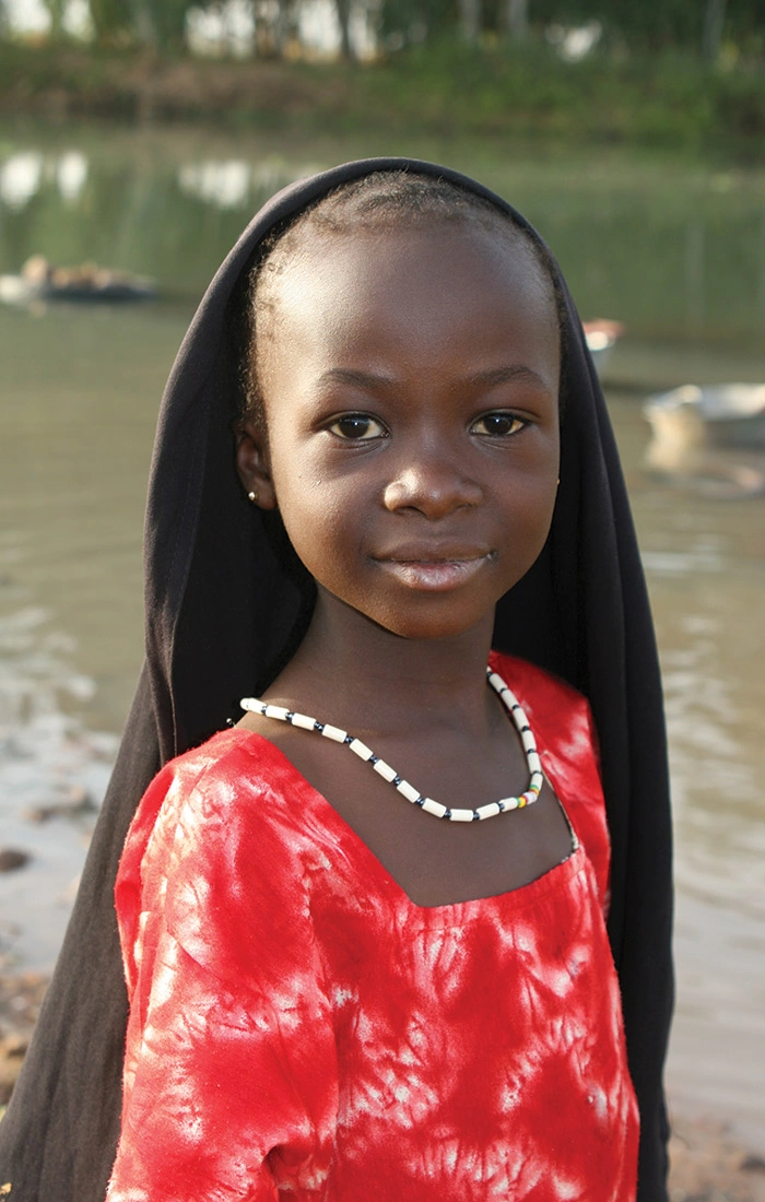 Girl by a river in Mali