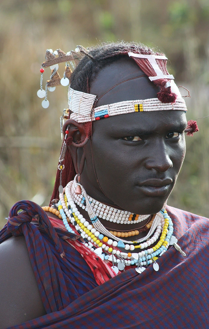 Young beautiful Maasai woman with traditional necklace poses for a