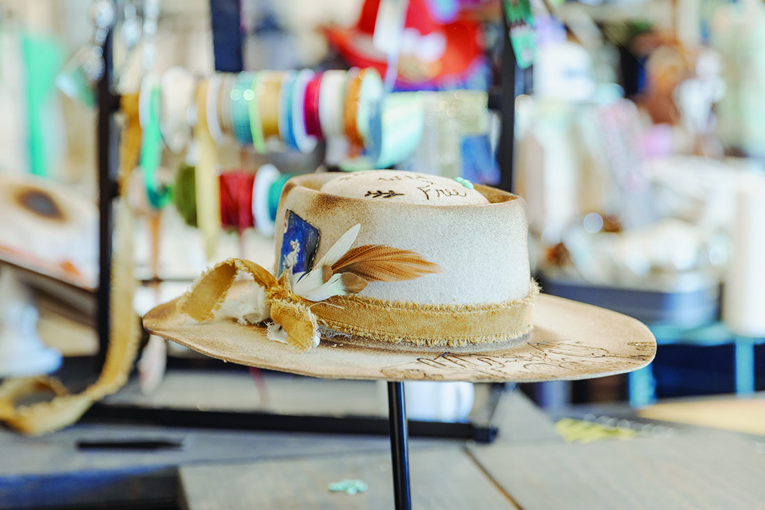 A finished Western-style hat on a stand.