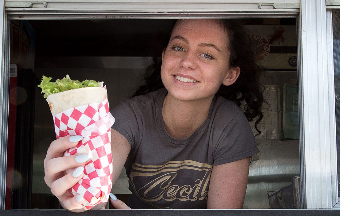woman serving food from a food truck