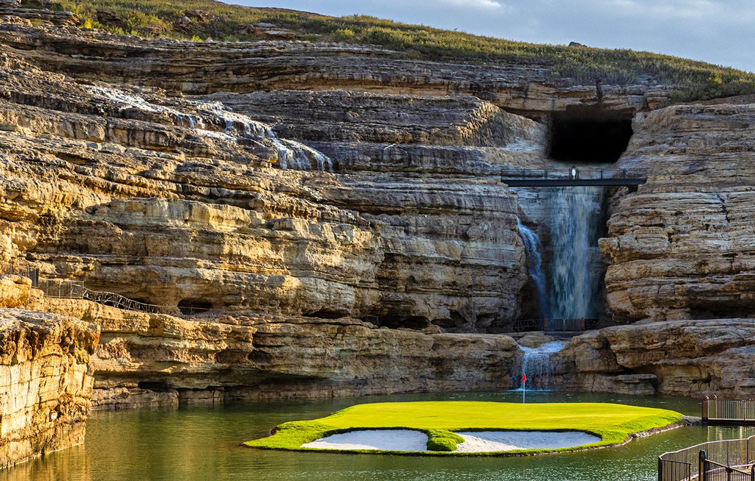 19th hole at Payne’s Valley Golf Course featuring a waterfall and an island green