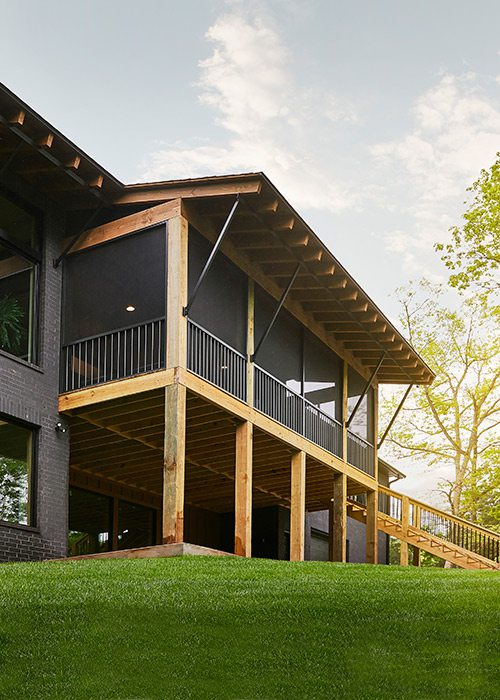 Screened in porch of rustic midcentury modern home in southwest Missouri