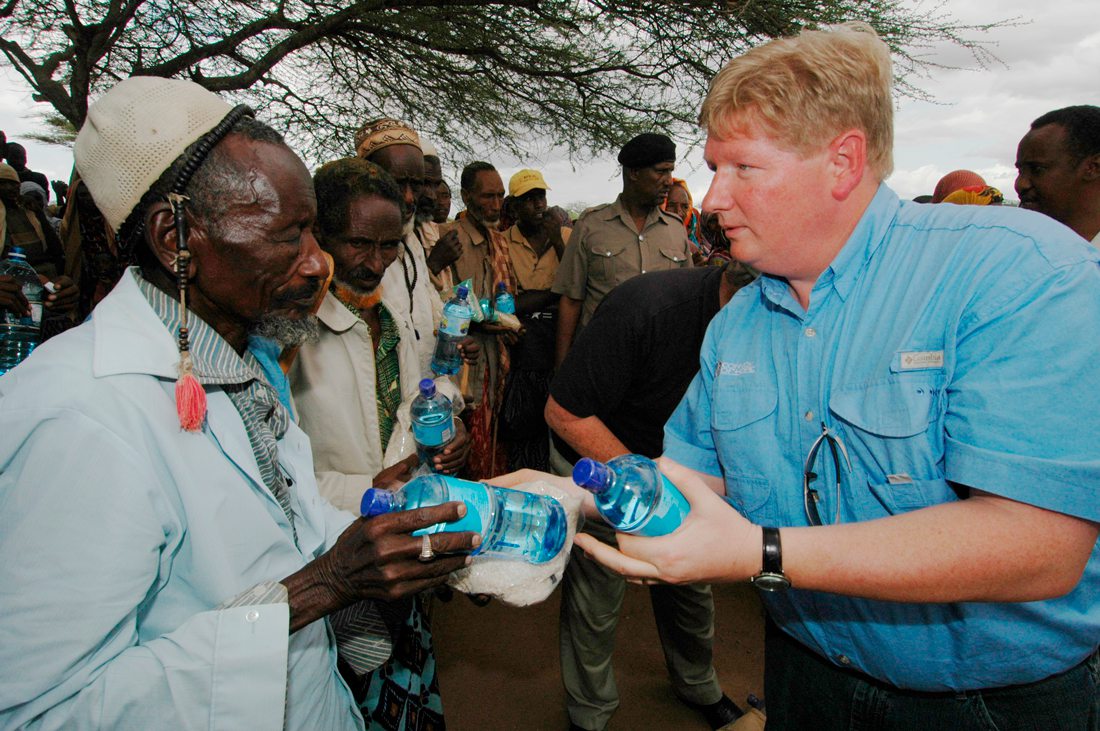 Hal Donaldson helps distribute water courtesy Convoy of Hope