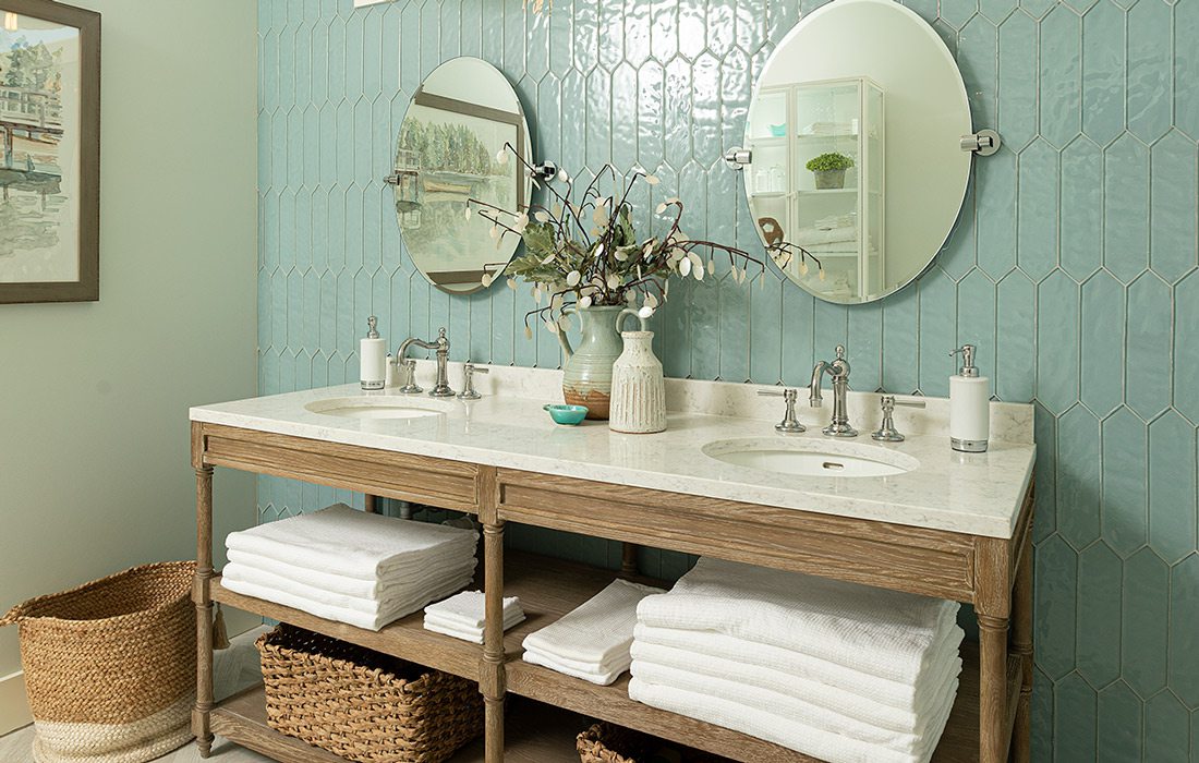 Teal tile in bathroom with two sinks