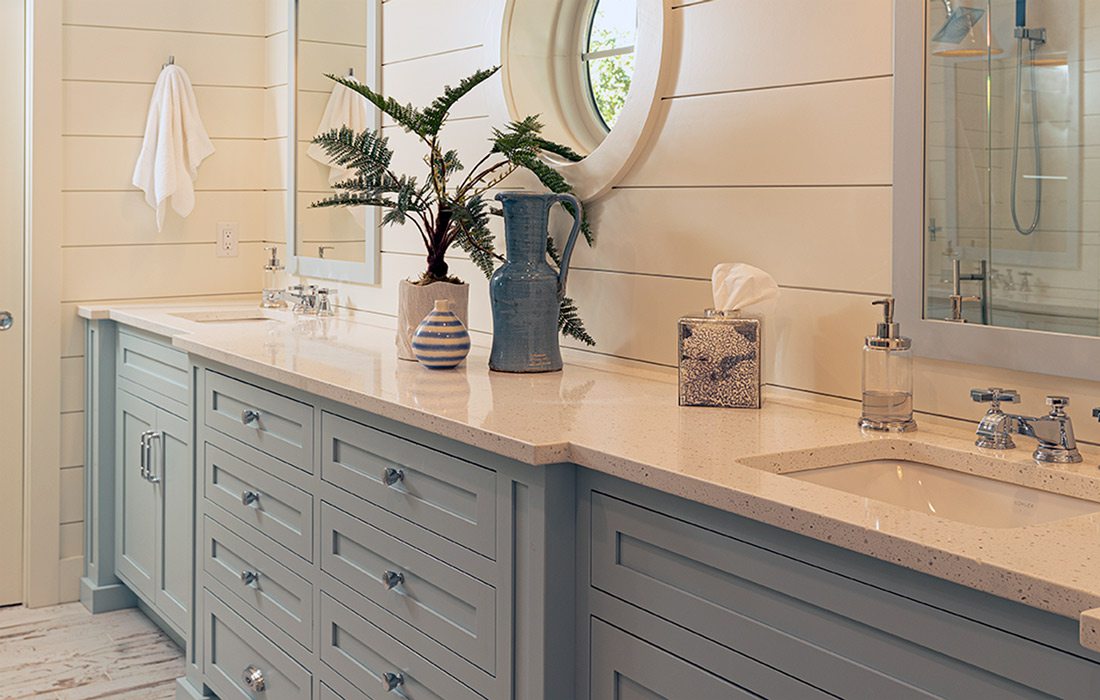 Bathroom with white tiling and background and blue cabinets