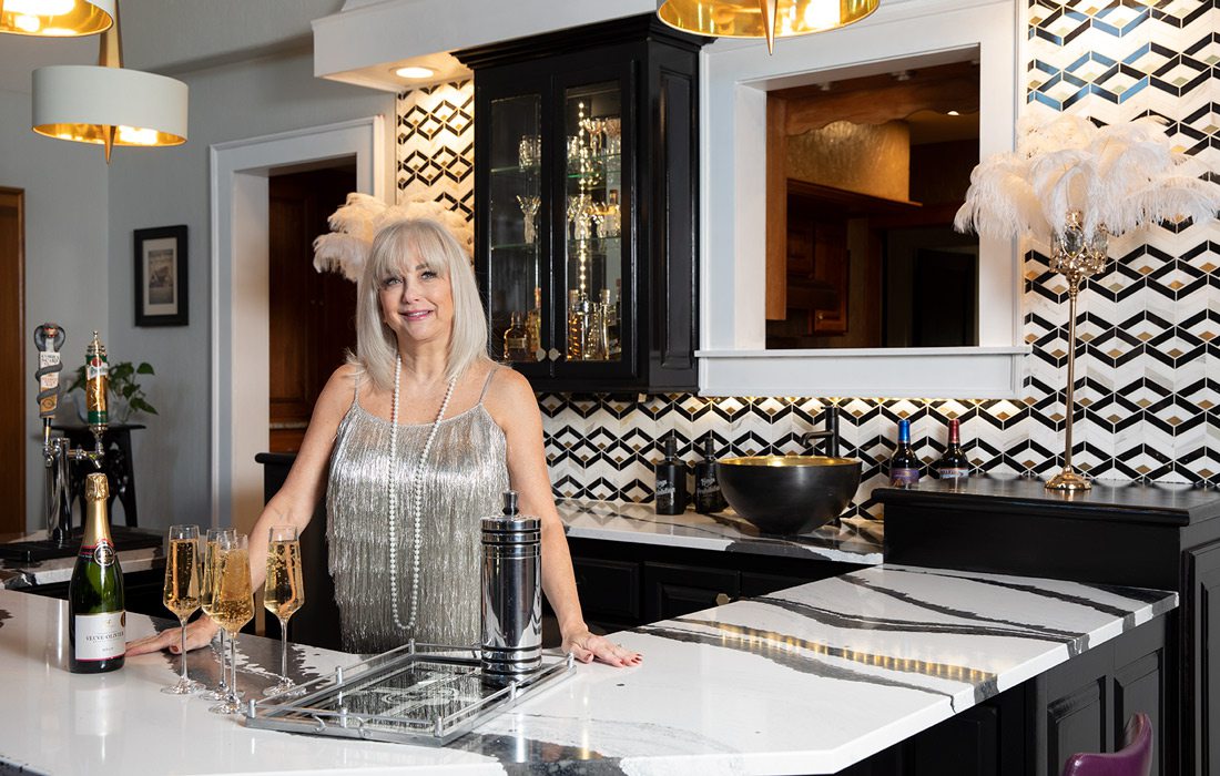 Woman poses at her in home bar