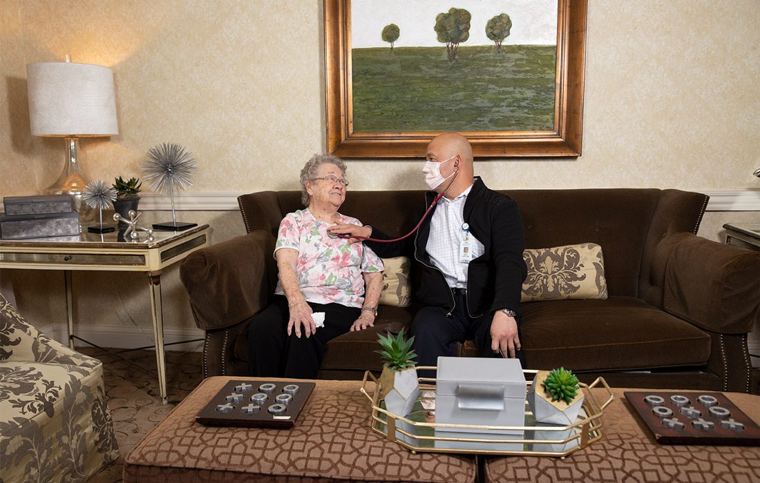 Dr. Martin Alumno of James River Nursing and Rehabilitation checking in with a resident.