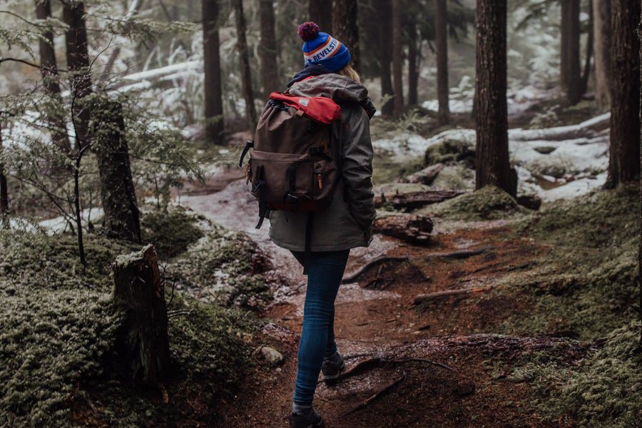 Woman hiking in the woods during winter.