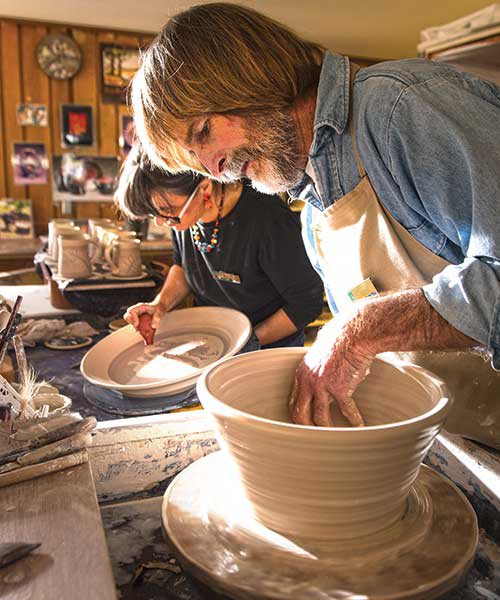 Judi and John work carefully to sculpt, mold, and clean their pottery creations.