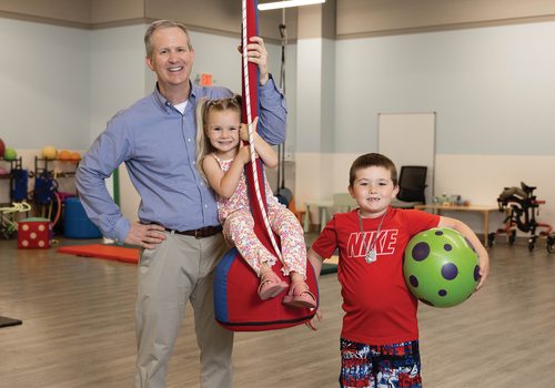 Dr. John and two patients at Autism and Neurodevelopmental Center.