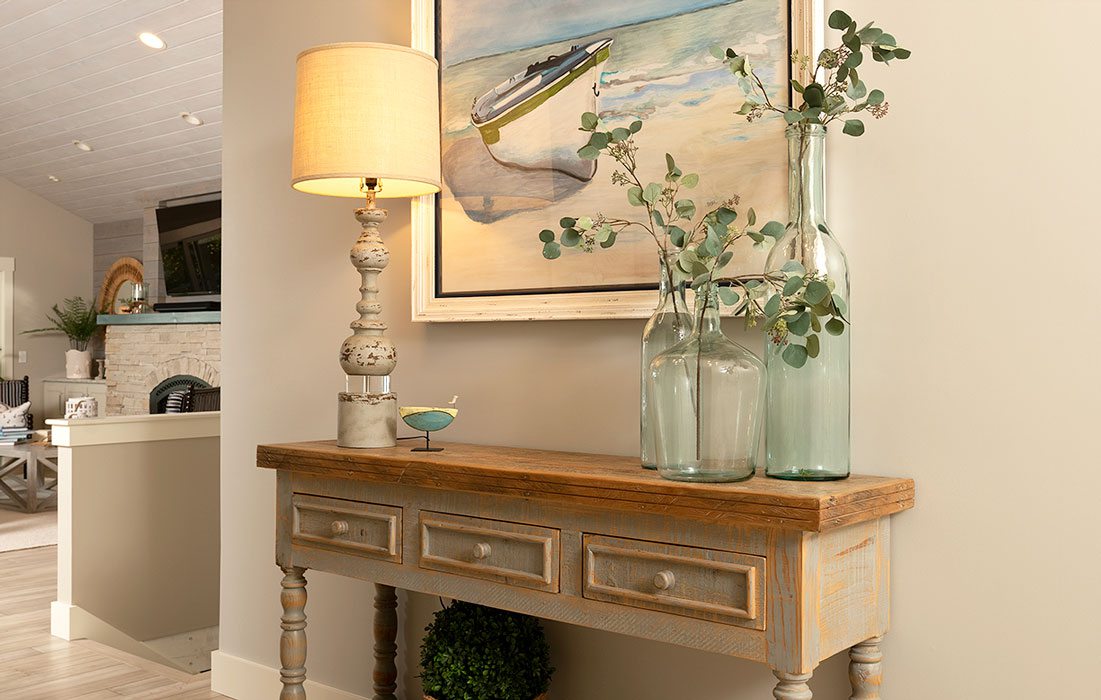 Table with blue vases and beach painting