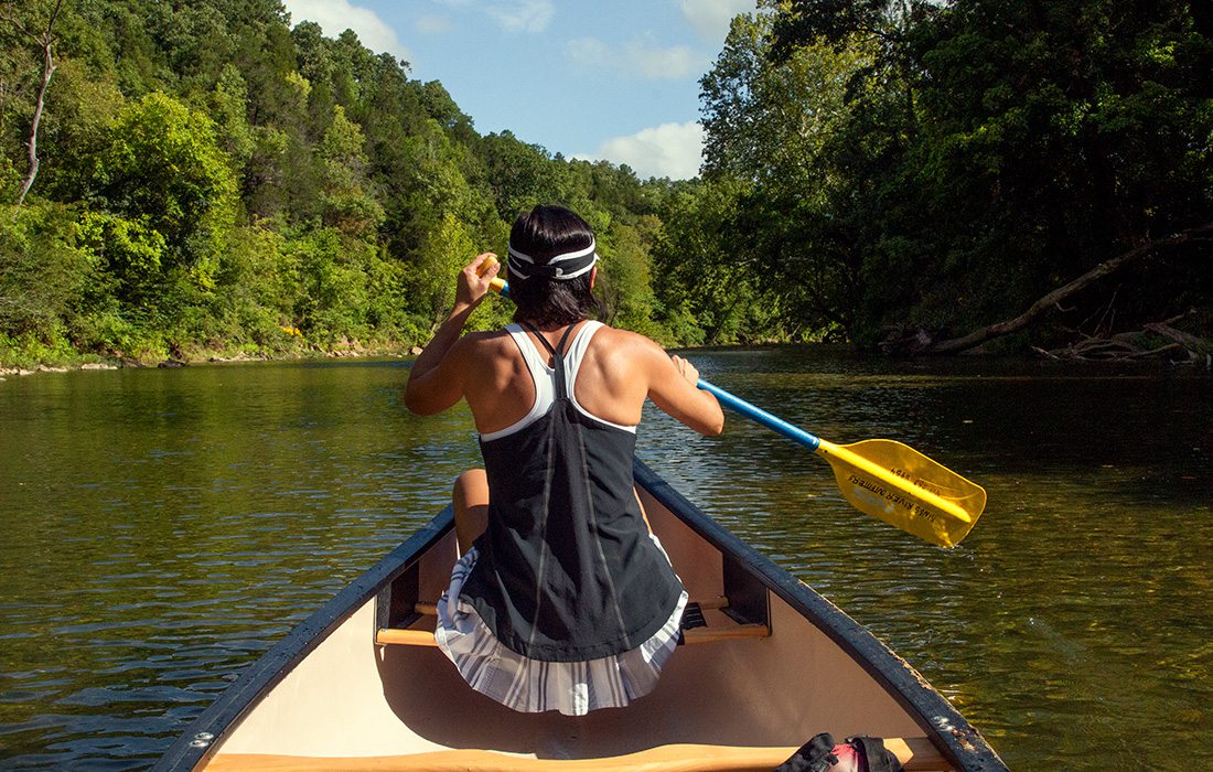 Woman paddling in a canoe on the Kings River