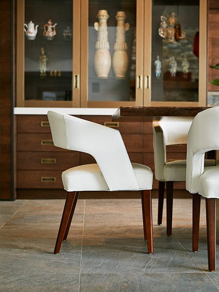 White barrel-back chair at midcentury design dining room table