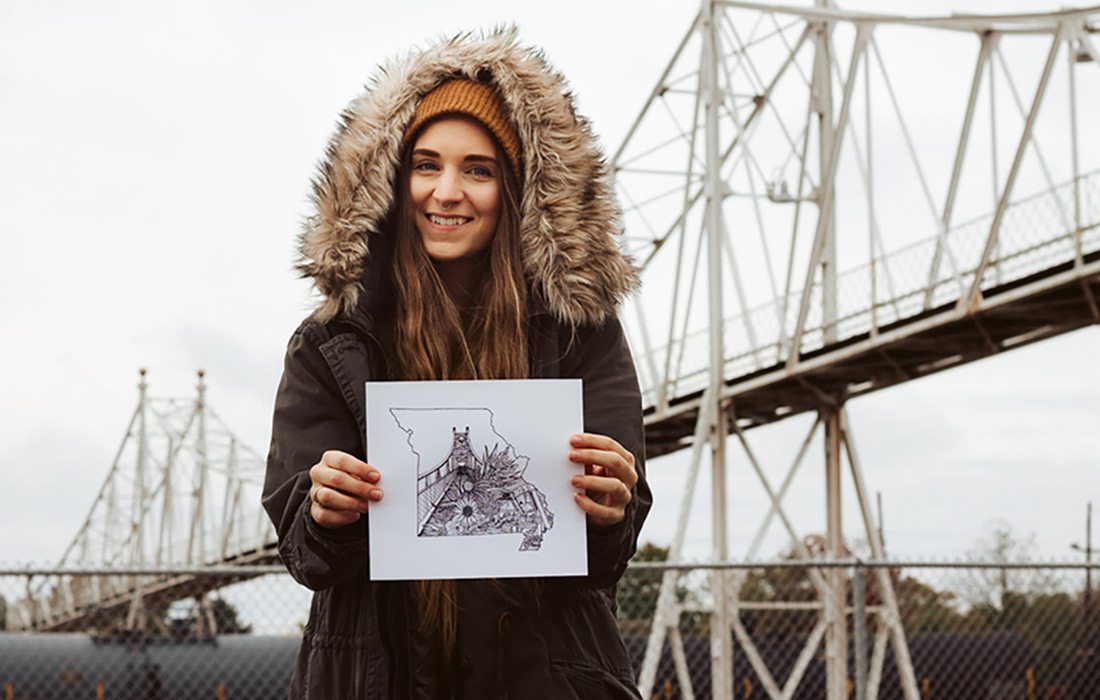 Artist and photographer Larissa Compton in front of C-Street’s Jefferson Avenue Footbridge in Springfield MO