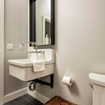 Slider Thumbnail: Minimalist bathroom with farmhouse sink by Jason Bekebrede.