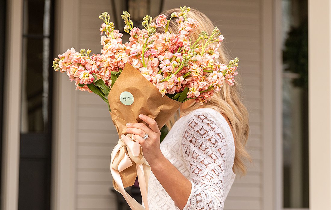 Jamie Stauffer holding a bouquet of flowers by Ozark Mtn Flower Truck in Springfield MO