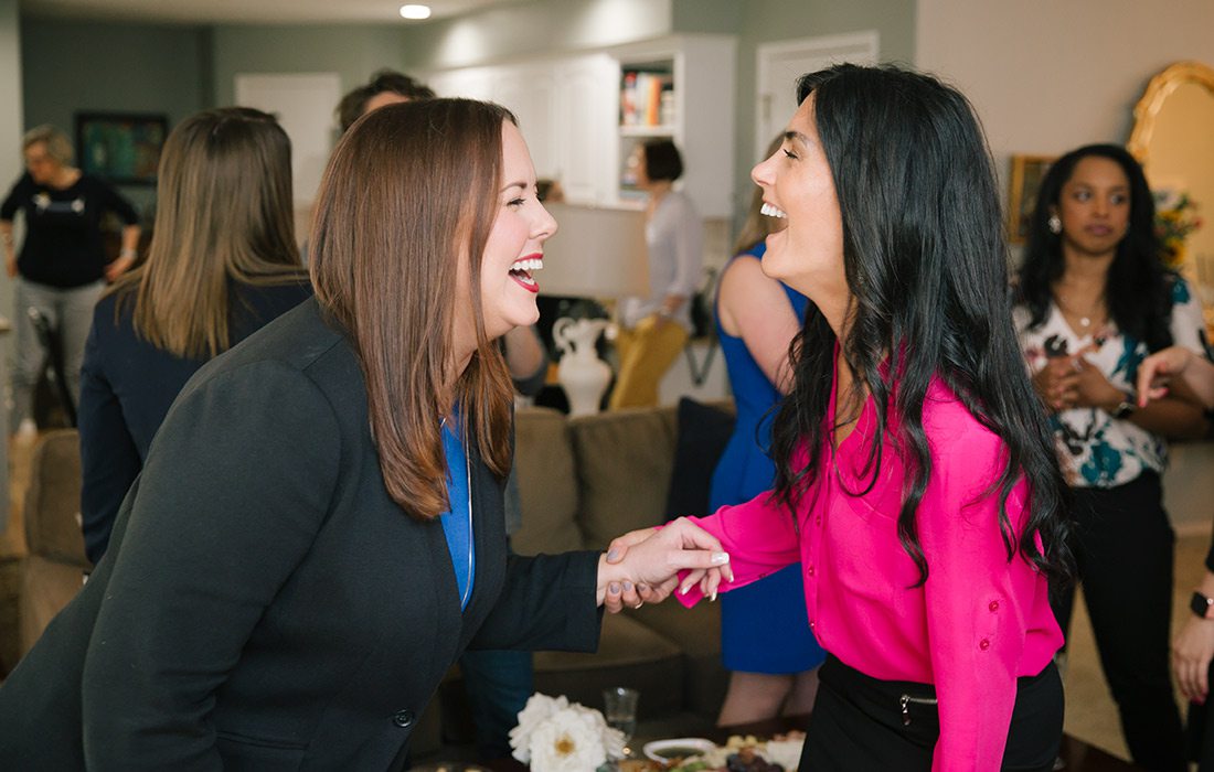 Ashley Norgard and Joelle Cannon talking at a networking event.